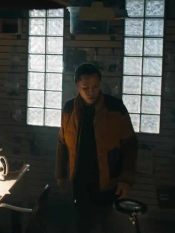 Tracker TV series Bob Exley yellow and black quilted puffer jacket, indoor cabin scene