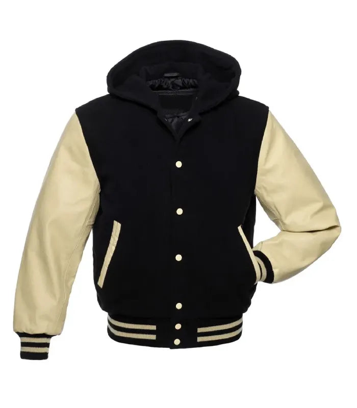 Front view of a black wool hooded varsity jacket with cream leather sleeves, cream snap buttons, and one hand inserted in the side pocket.