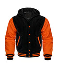 Front view of a black and orange hooded varsity jacket featuring orange leather sleeves, contrast snap buttons, orange-trimmed pockets, and attached hood.
