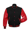 Front pose view of a black wool varsity jacket with red leather sleeves and red snap buttons, showing one hand inserted in the pocket.
