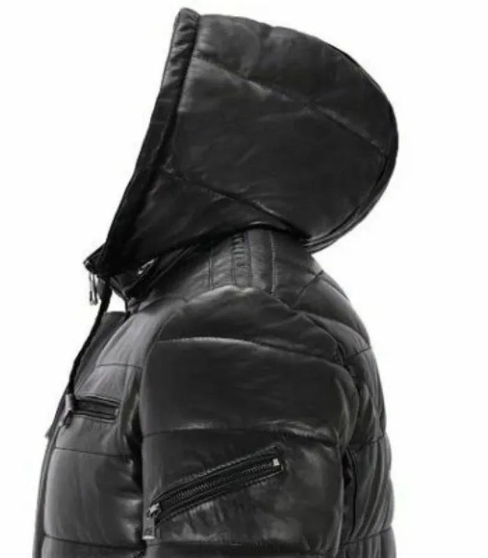 Side close-up view of a Black Hooded Leather Puffer Jacket featuring an upper arm zippered pocket, quilted leather hood, and horizontal sleeve baffles.