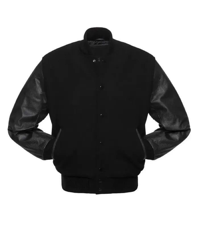 Front view of an all-black varsity jacket displaying both hands tucked into side welt pockets, snap closure front, and matching solid black ribbed trim.