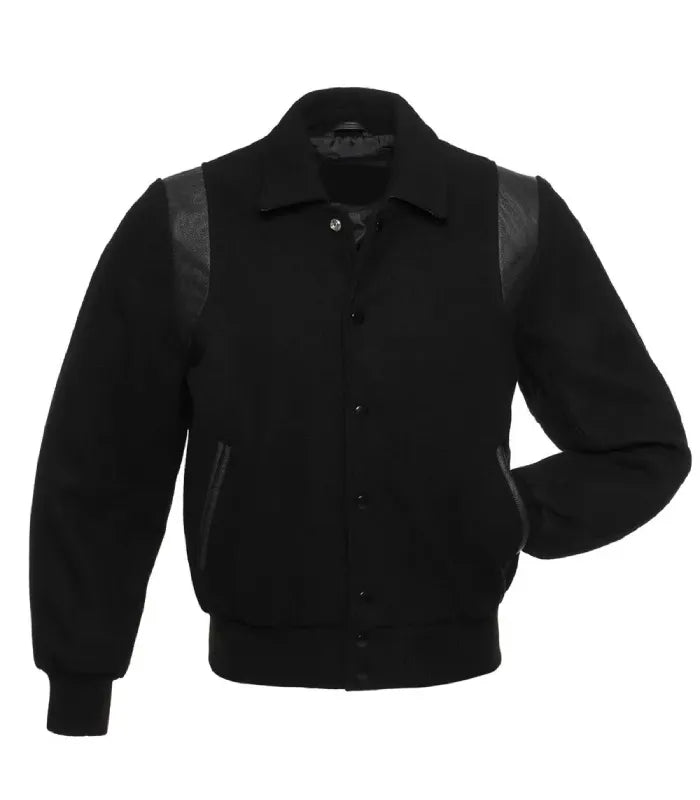 A black varsity-style jacket with black leather shoulder panels and side pockets, shown against a plain white background.