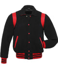 Straight front view of black wool varsity jacket featuring shirt collar, red contrast shoulder panels, and snap closure.