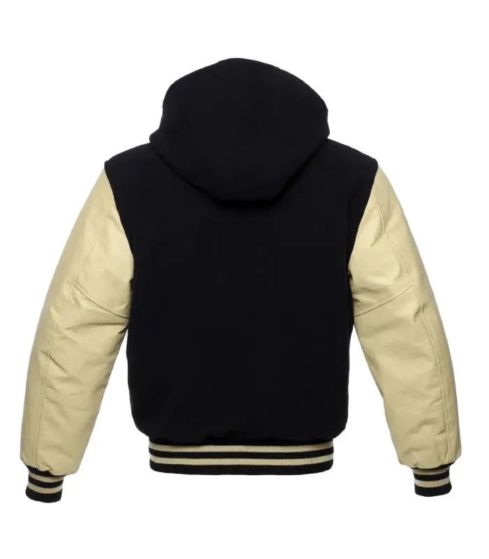 Rear view of a black and cream hooded varsity jacket with cream leather sleeves, full wool hood, plain black body, and cream-striped rib-knit hem.
