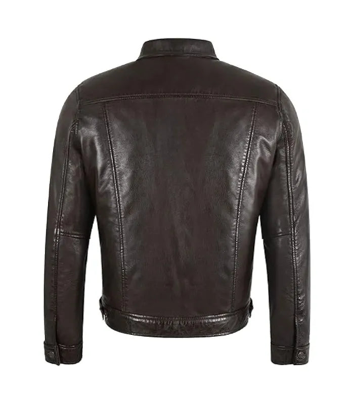 Rear perspective of a dark brown leather trucker jacket displaying structured panel lines and back yoke stitching.