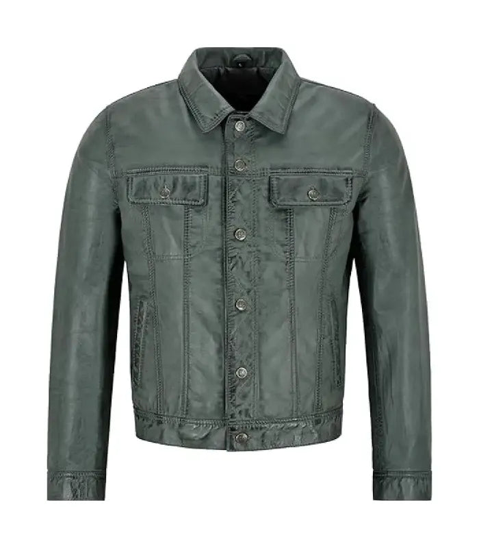 Front view of a dark grey leather trucker jacket featuring twin buttoned flap chest pockets, central metal button closure, and a structured collar.