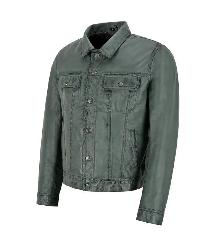 Three-quarter front angle view of a dark grey leather trucker jacket highlighting chest flap pockets, front button placket, and side welt pocket.