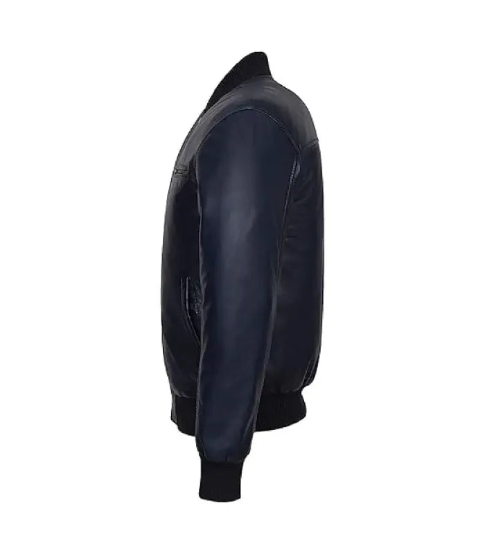Side profile view of a navy leather bomber jacket showing sleeve paneling, side welt pocket, and black ribbed cuff.