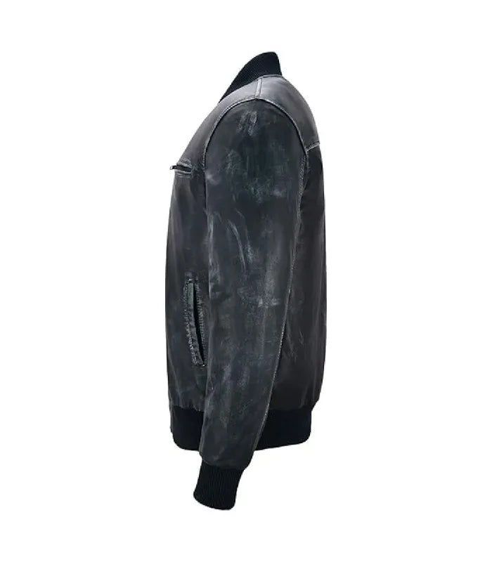 Side profile view of a distressed vintage navy leather bomber jacket displaying sleeve seam stitching and black ribbed cuffs.
