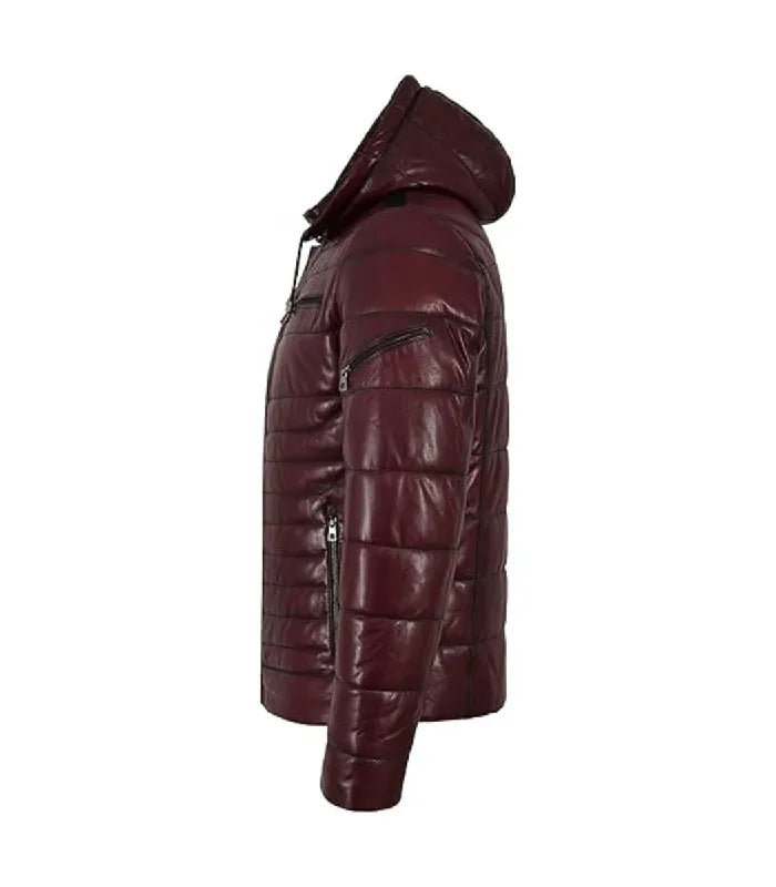 A side profile view of a dark burgundy quilted puffer jacket with a hood and black zippers, shown against a plain white background.