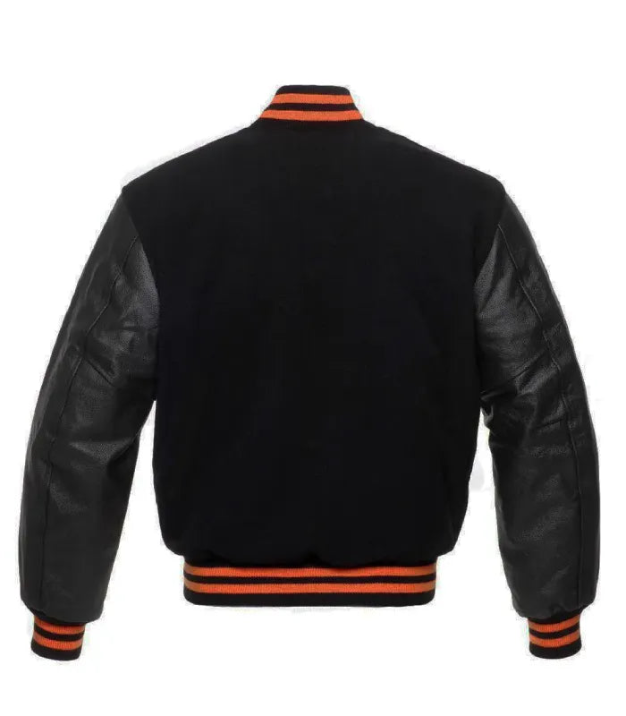 Rear view of an Orange Knit Trim Black Varsity Jacket featuring a black wool body, leather sleeves, and orange striped rib-knit collar, hem, and cuffs.