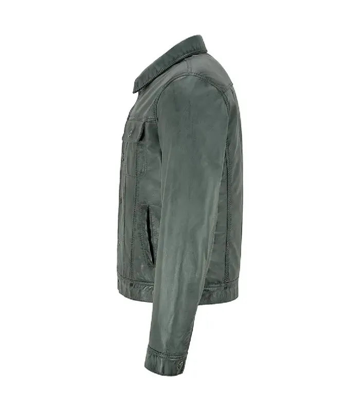 Side profile view of a dark grey leather trucker jacket showing sleeve panel seam, buttoned wrist cuff, shirt collar, and side pocket entrance.
