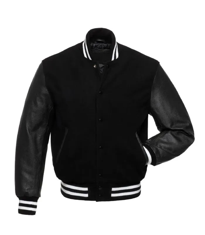 Front pose view of a black varsity jacket with leather sleeves, featuring one hand inserted in the pocket to showcase fit and leather sleeve detail.