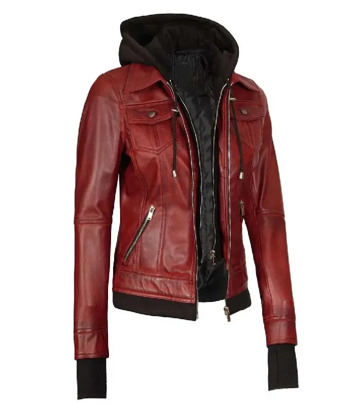 Three-quarter angle view of a women's red hooded leather bomber jacket highlighting the layered double zipper structure, chest flap pockets, and extended black wrist cuffs.